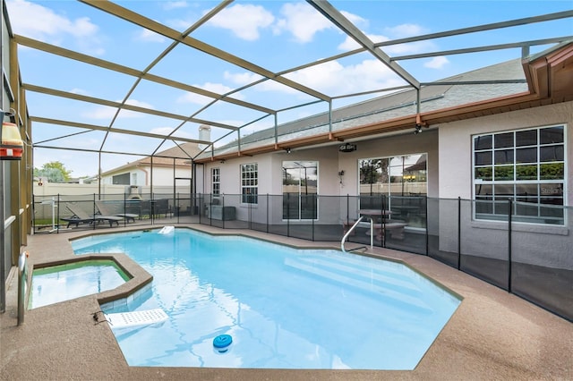 view of pool with glass enclosure and a patio