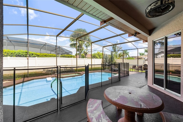 view of swimming pool with a patio and a lanai