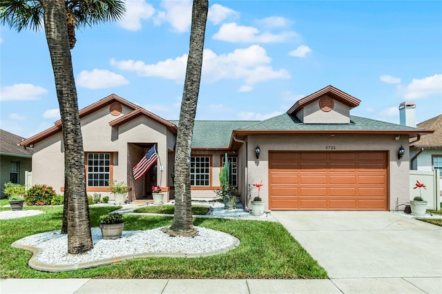 view of front facade with a garage and a front yard