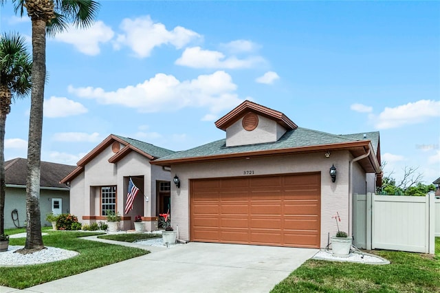 view of front of home with a garage and a front lawn