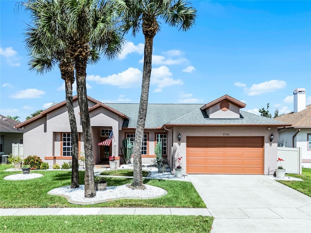 view of front of home with a garage and a front yard