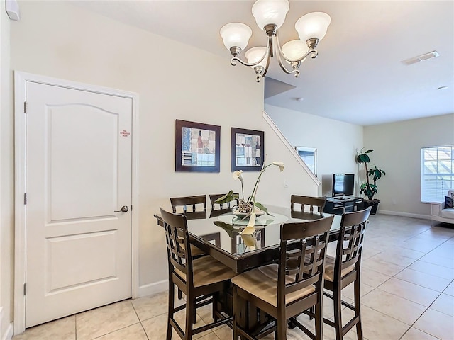 8967 California Palm Rd, Kissimmee, FL 34747 - dining area with visible vents, baseboards, a notable chandelier, and light tile patterned floors