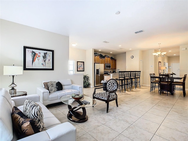 tiled living room featuring a notable chandelier