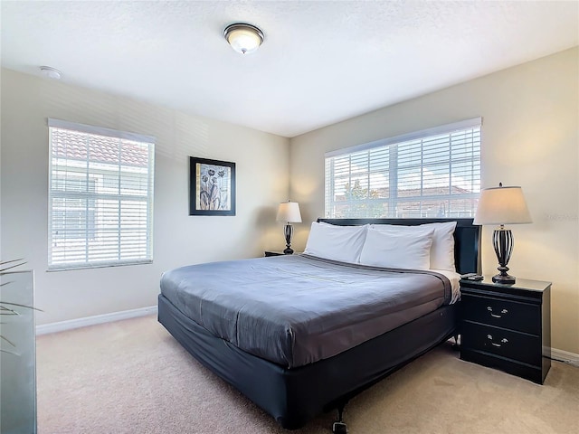 bedroom featuring light carpet