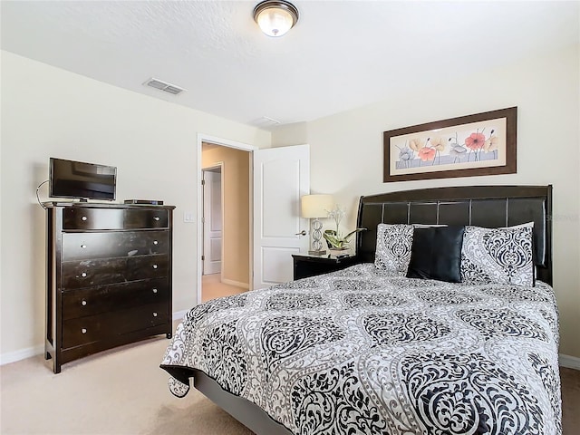 bedroom featuring light carpet