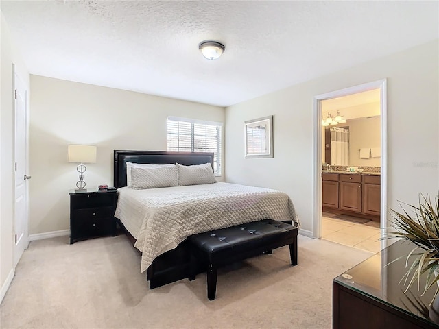 8967 California Palm Rd, Kissimmee, FL 34747 - bedroom featuring light carpet, an inviting chandelier, baseboards, and connected bathroom