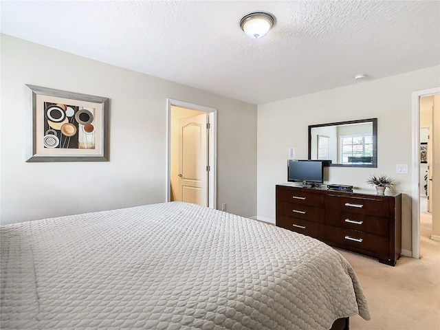 carpeted bedroom featuring a textured ceiling