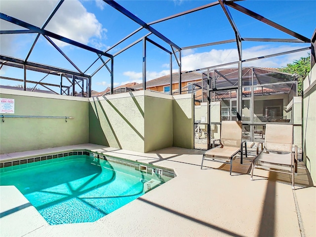 view of pool with a lanai and a patio area