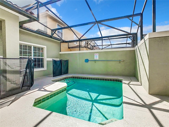 view of swimming pool featuring a lanai and a patio area