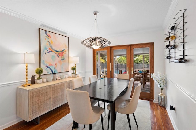 dining area featuring crown molding, dark hardwood / wood-style flooring, and french doors