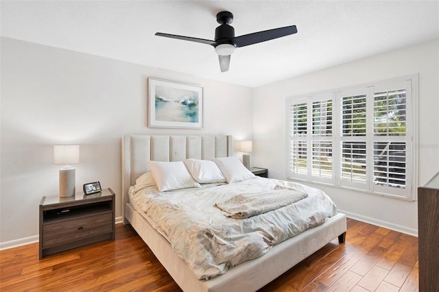 bedroom with ceiling fan and dark hardwood / wood-style flooring