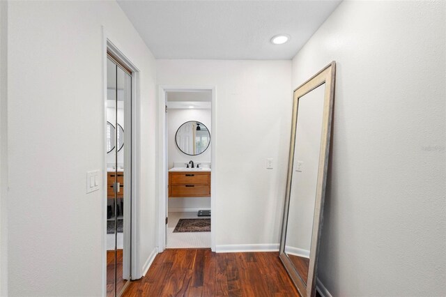 hallway featuring sink and dark hardwood / wood-style flooring