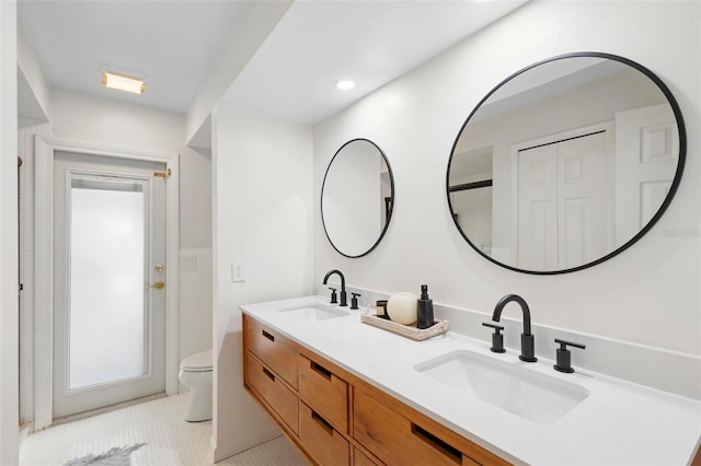 bathroom with tile patterned floors, vanity, and toilet