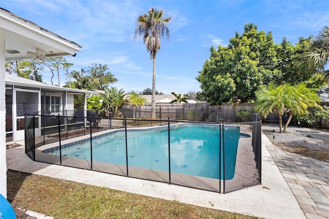 view of pool with ceiling fan and a sunroom