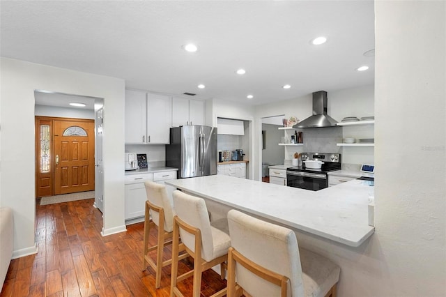 115 Marcy Blvd, Longwood, FL 32750 - kitchen featuring open shelves, white cabinetry, appliances with stainless steel finishes, wall chimney range hood, and dark wood-type flooring