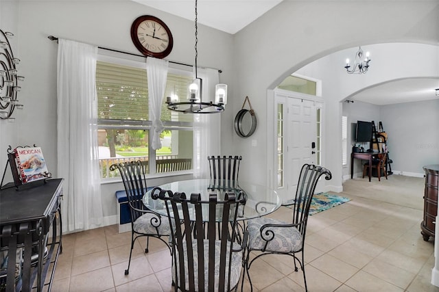 dining space featuring light tile patterned flooring and a chandelier