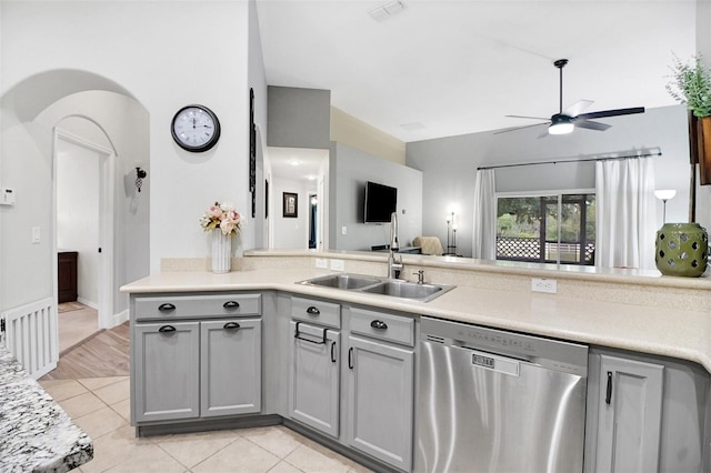 kitchen with gray cabinets, dishwasher, light tile patterned floors, and sink