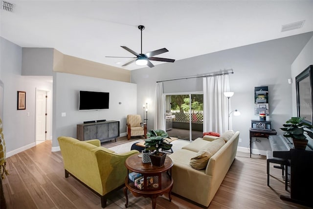 living room featuring hardwood / wood-style flooring and ceiling fan