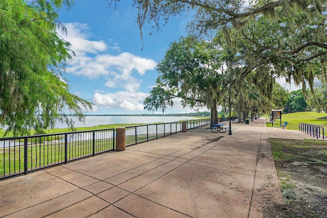 view of community with a yard and a water view