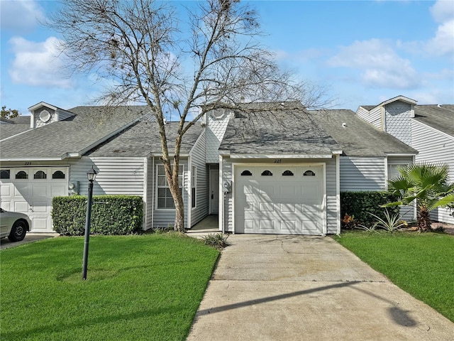 view of front of home with a front yard and a garage