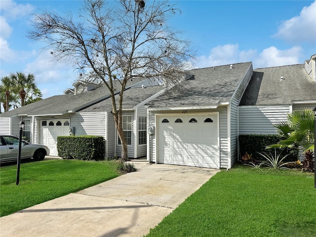 view of front facade with a front yard and a garage