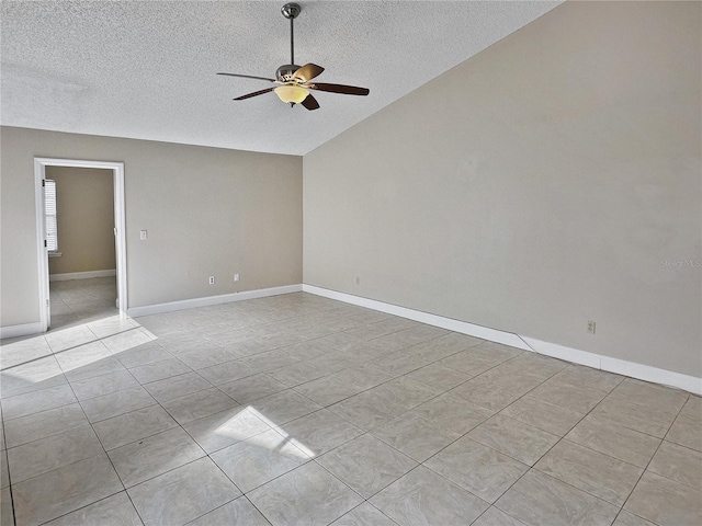 unfurnished room with a textured ceiling, light tile patterned floors, vaulted ceiling, and ceiling fan