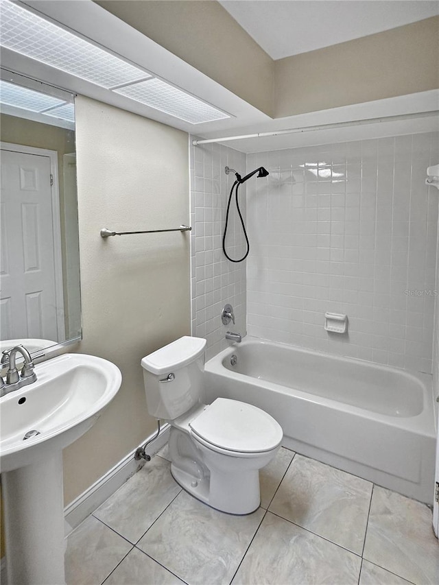 bathroom with tiled shower / bath combo, tile patterned floors, and toilet