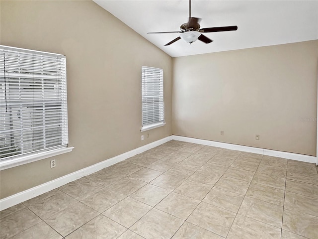 tiled empty room featuring lofted ceiling and ceiling fan