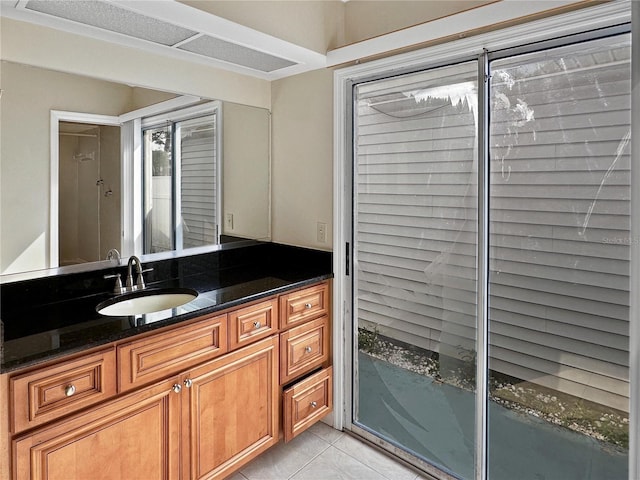 bathroom with tile patterned flooring and vanity