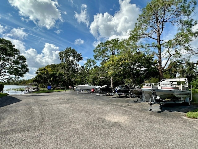 view of parking / parking lot with a water view