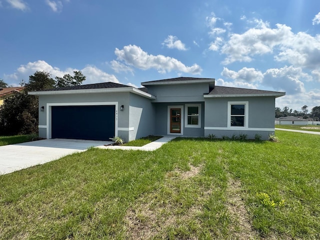 view of front of house with a front yard and a garage