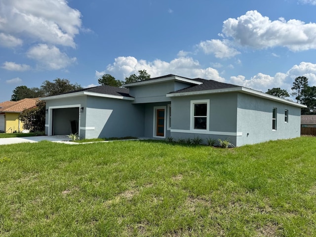 view of front facade with a garage and a front yard