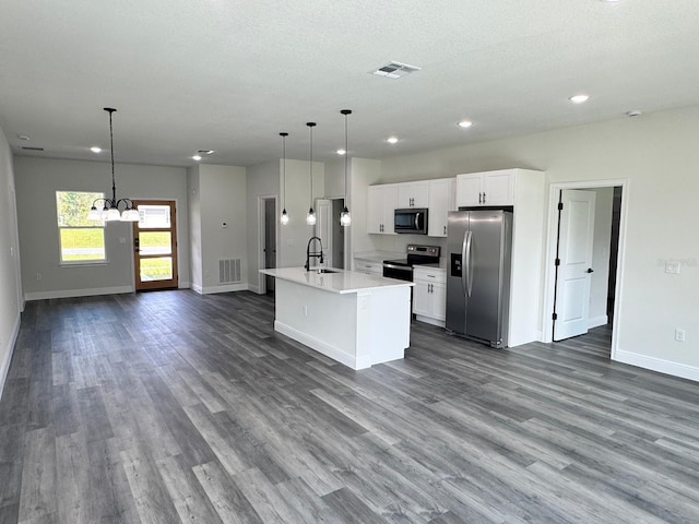 kitchen featuring white cabinets, stainless steel appliances, dark wood-type flooring, and sink