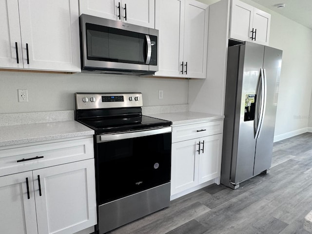 kitchen featuring white cabinetry, stainless steel appliances, and light hardwood / wood-style flooring