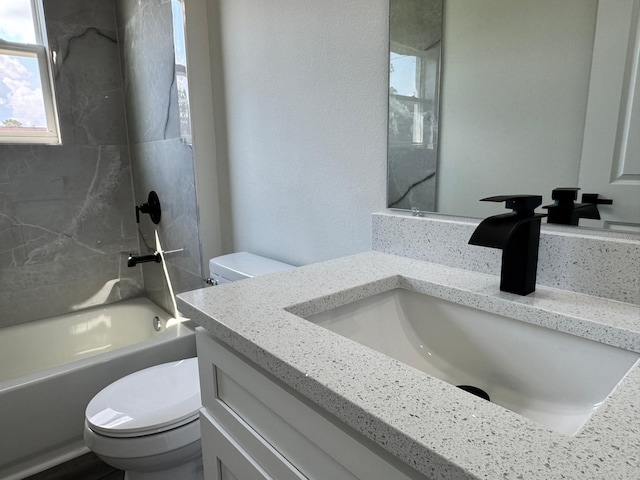 full bathroom with tiled shower / bath combo, vanity, and toilet