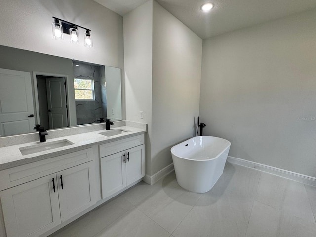 bathroom featuring tile patterned flooring, a bathtub, and vanity