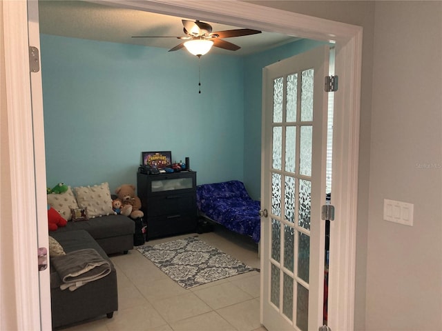 tiled bedroom featuring ceiling fan