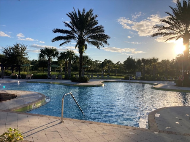 view of pool at dusk