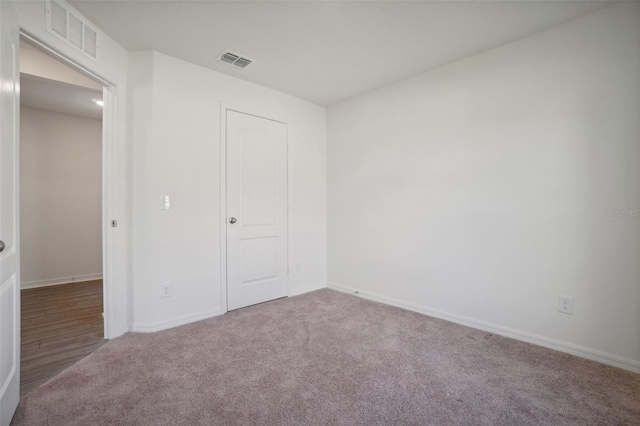 unfurnished bedroom featuring a closet and carpet floors