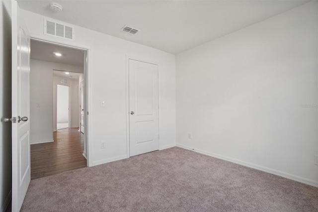 unfurnished bedroom featuring hardwood / wood-style floors and a closet