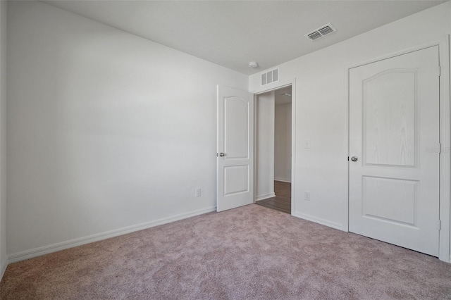 unfurnished bedroom with light carpet