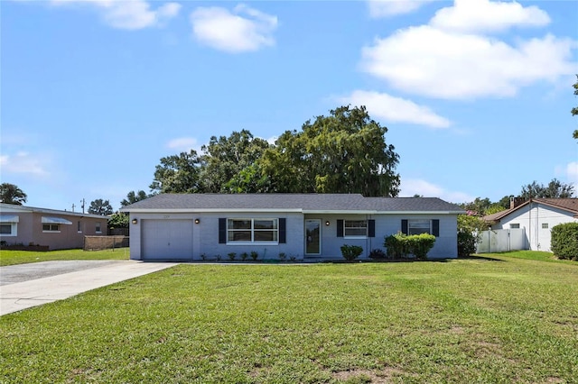 ranch-style house featuring a front yard and a garage