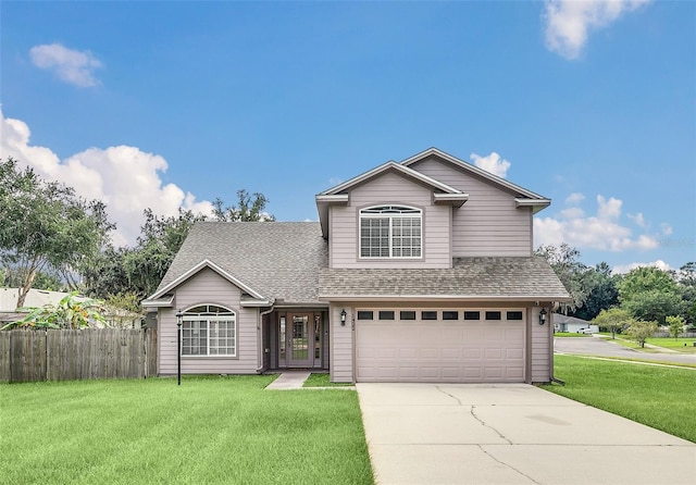 front facade featuring a front lawn and a garage