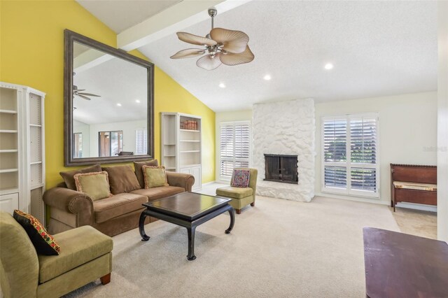 carpeted living room with a textured ceiling, lofted ceiling with beams, and a fireplace