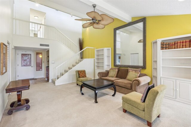 carpeted living room featuring beamed ceiling, high vaulted ceiling, and ceiling fan