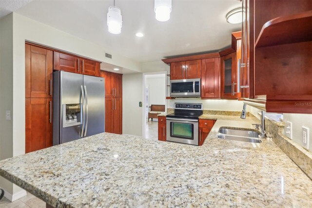 kitchen featuring sink, hanging light fixtures, stainless steel appliances, kitchen peninsula, and light tile patterned flooring