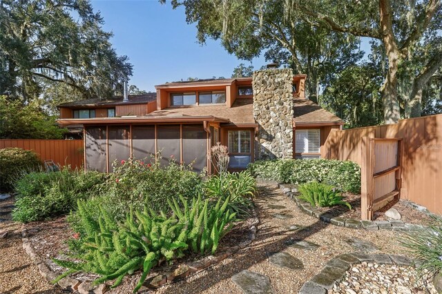 back of property with a sunroom