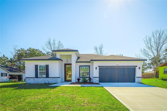 prairie-style home with a front lawn and a garage