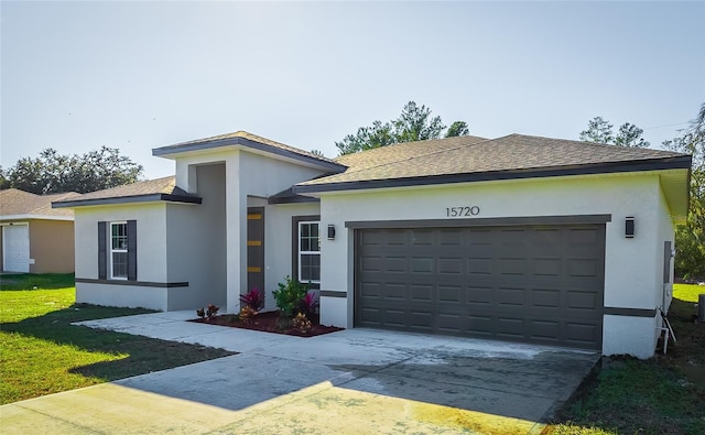 view of front of house with a garage and a front lawn