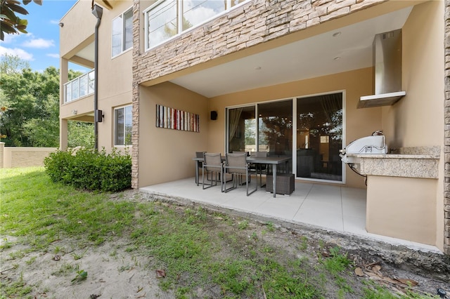 back of house featuring a balcony and a patio area